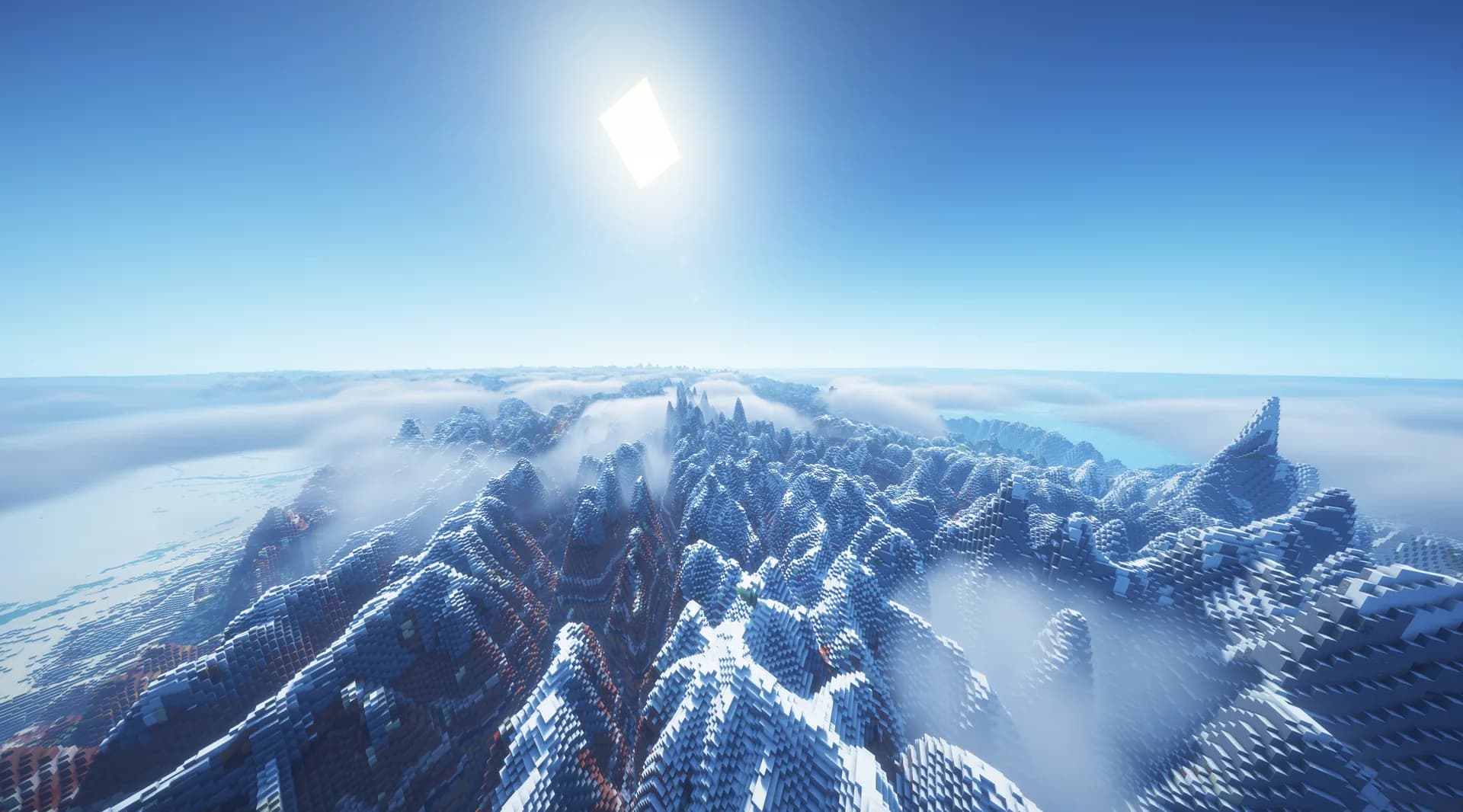 Cordillera nevada sobre un mar de nubes con el sol alto y cielo despejado