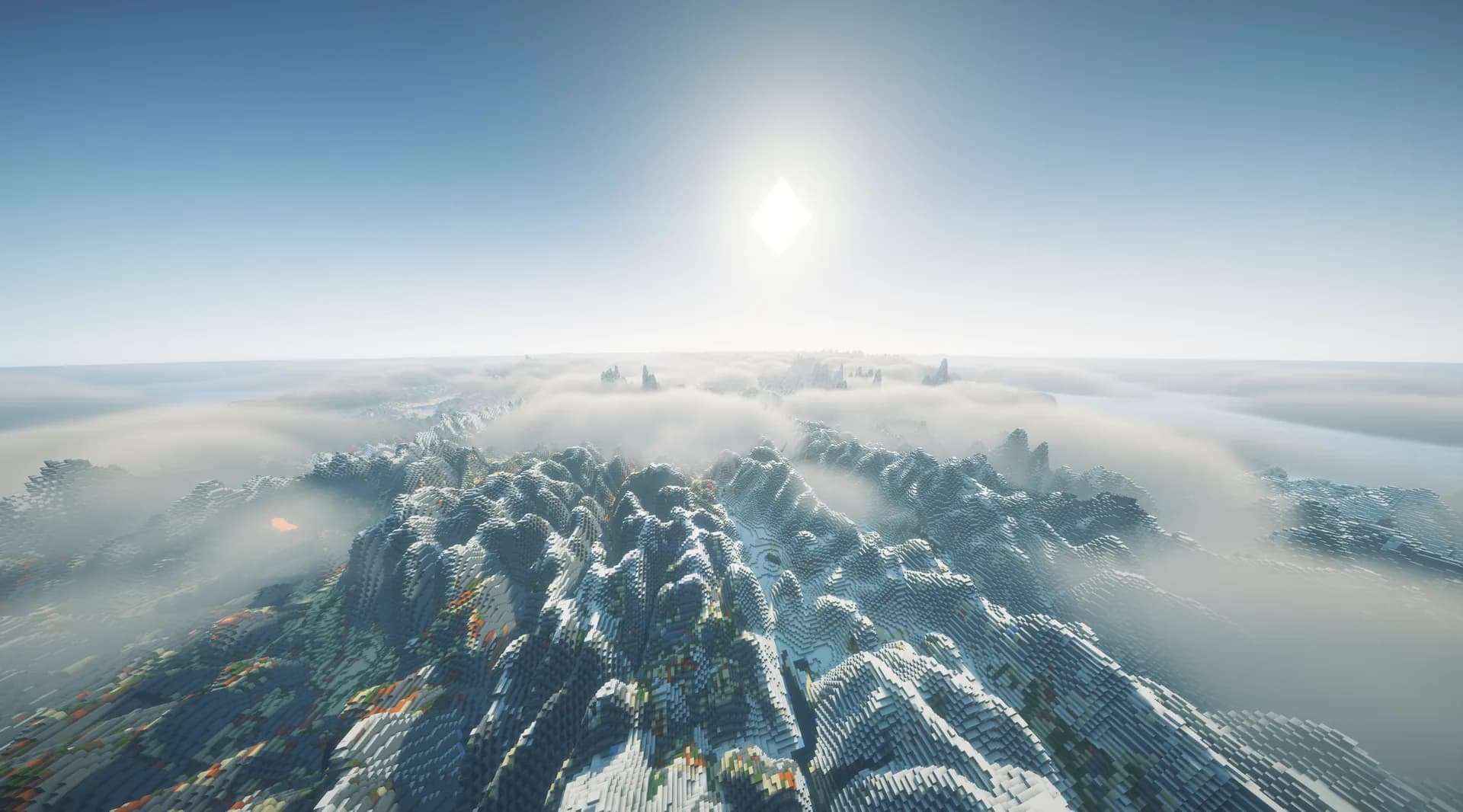 Montañas nevadas emergiendo de la niebla al amanecer