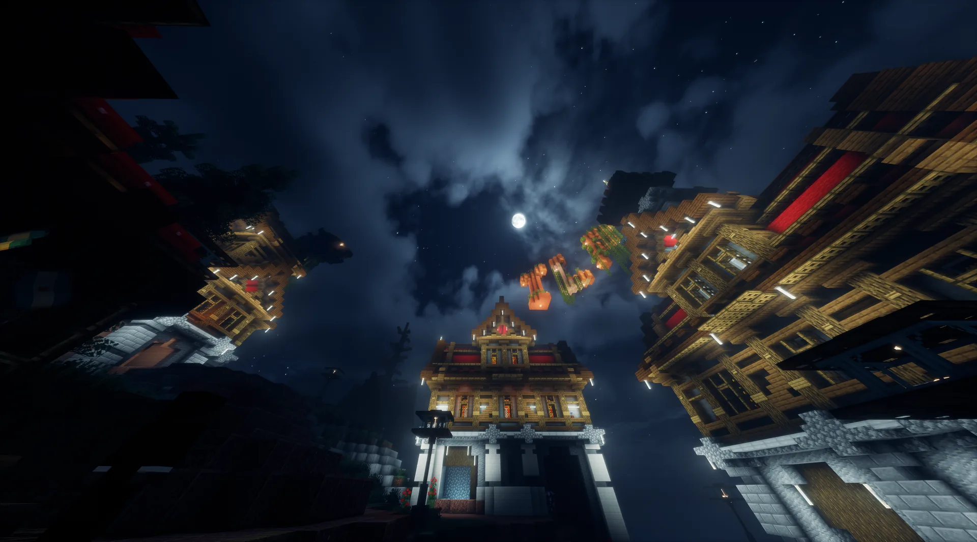 Pagodas iluminadas de noche vistas desde abajo, con la luna entre las nubes